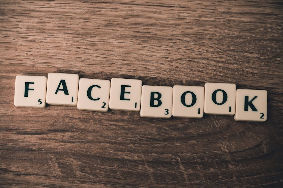 Scrabble tiles spelling 'Facebook' on a wood background, symbolizing social media